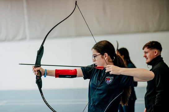 A young person trying Archery at a School Games event