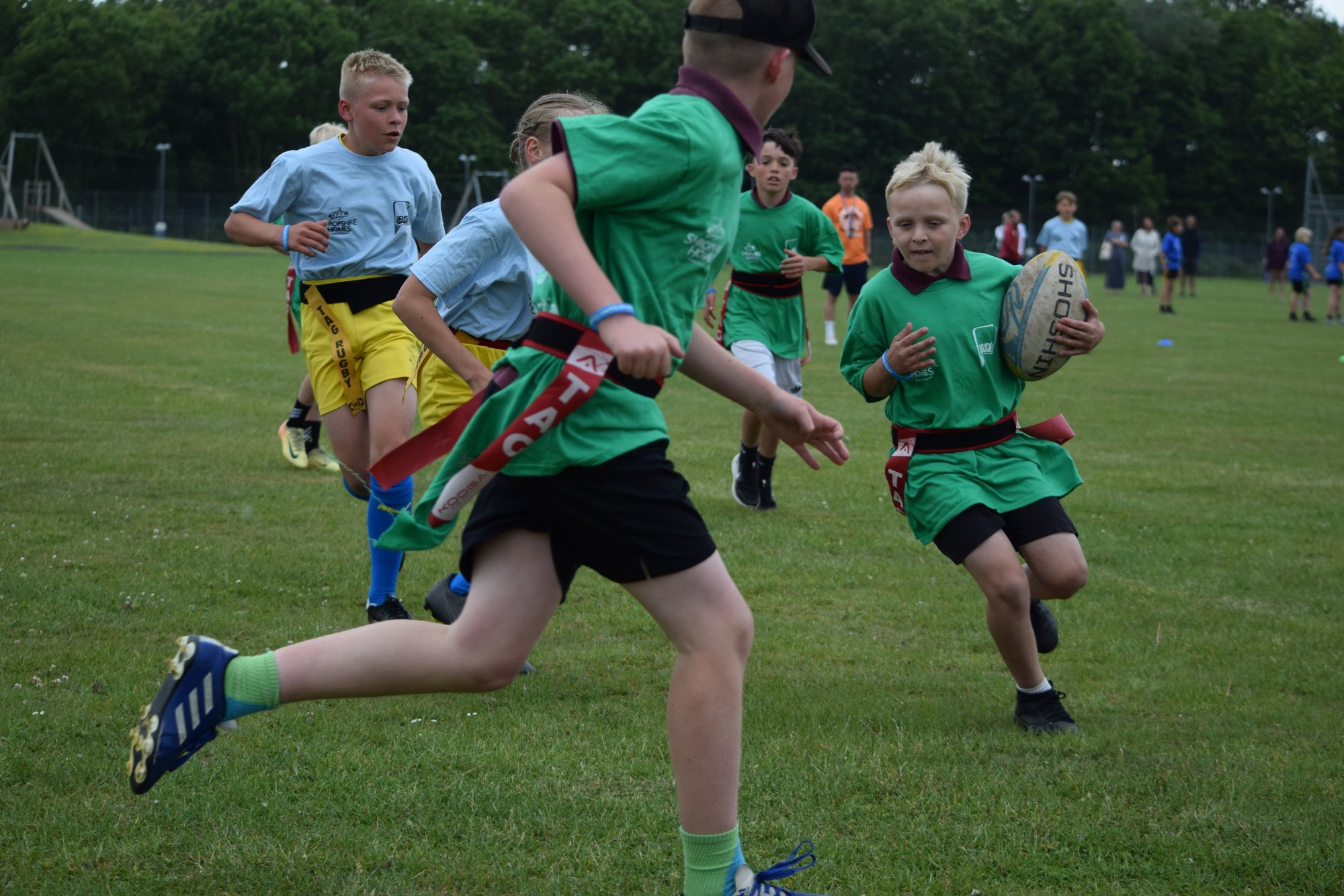 A photo of young people playing tag rugby at a School Games event