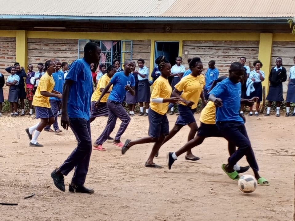 A photo of Kenyan school pupils wearing t-shirts we have donated to them.