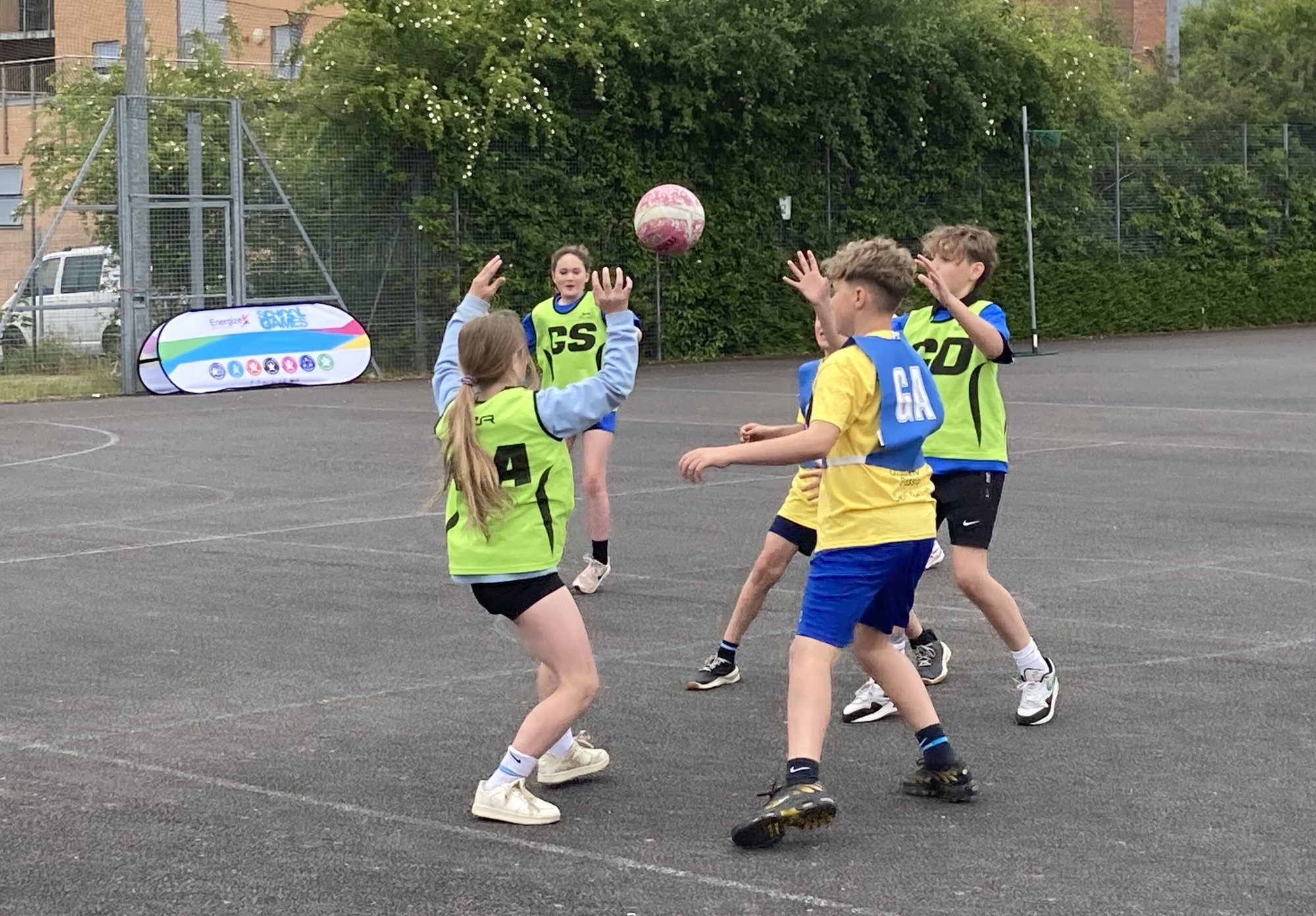 A photo taken of young people playing Netball at a School Games event.