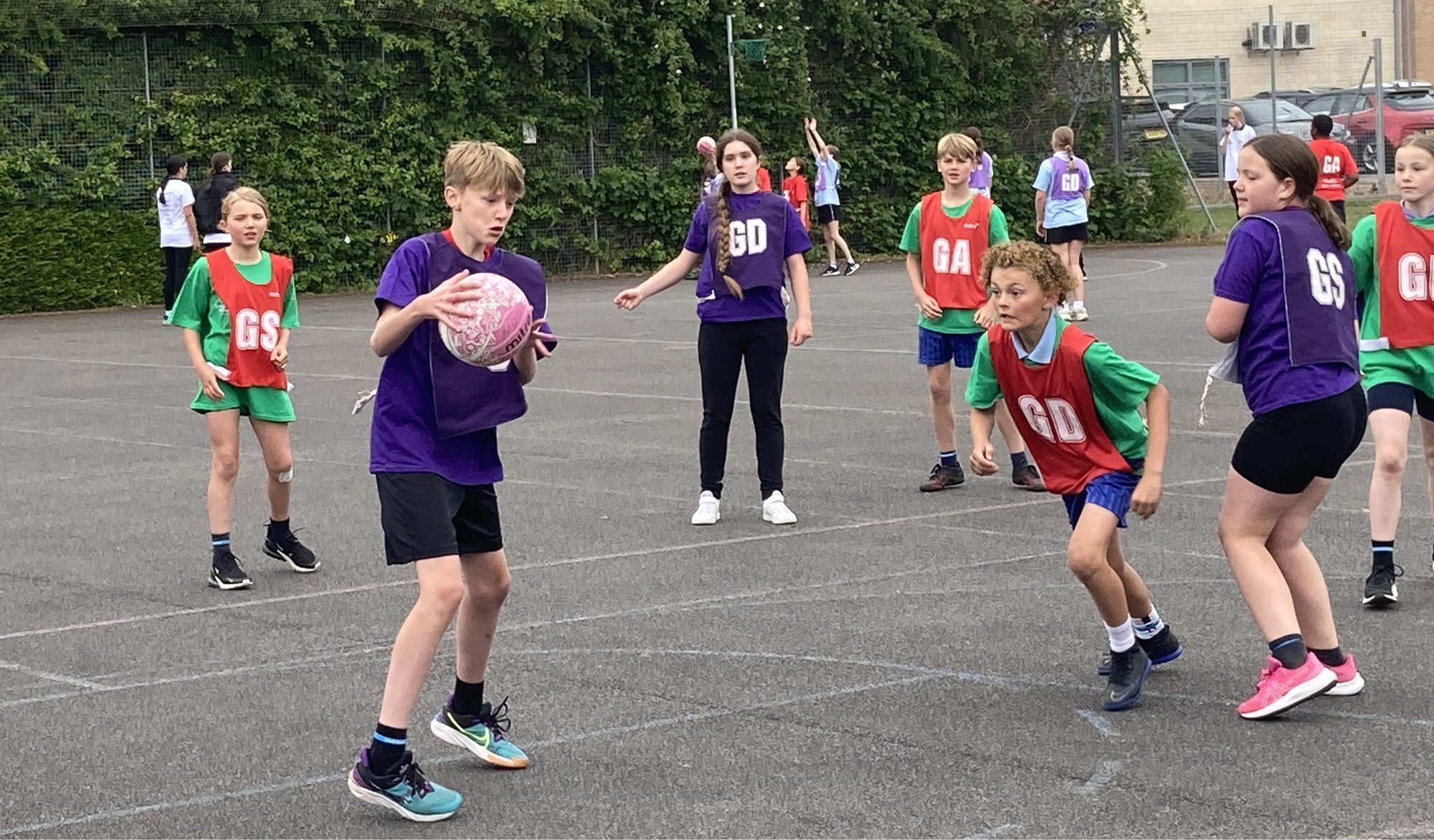 Young people playing Netball at a School Games event.