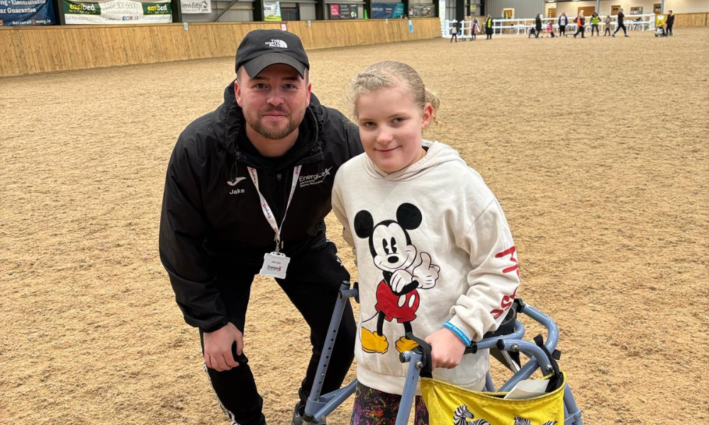 A photo of Jake Jones with a young person taking part of an Inclusion event.