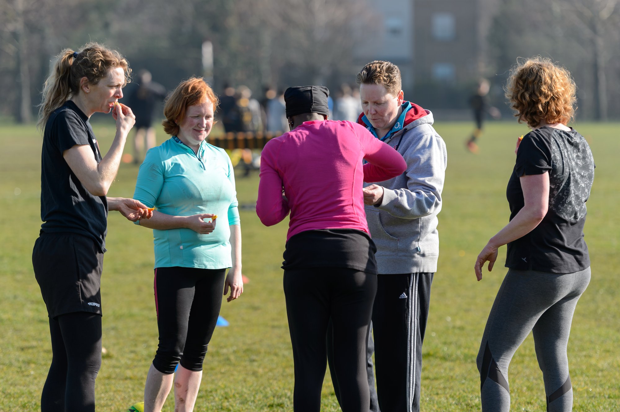 Females taking a break at a rugby training session