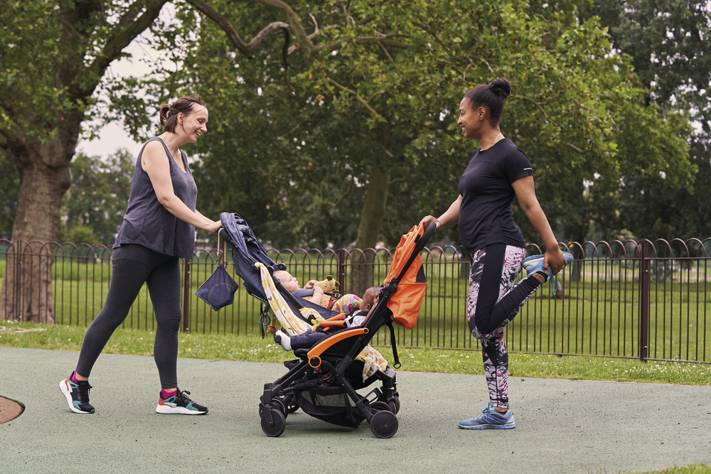 Ladies with babies in buggies doing activity in a park